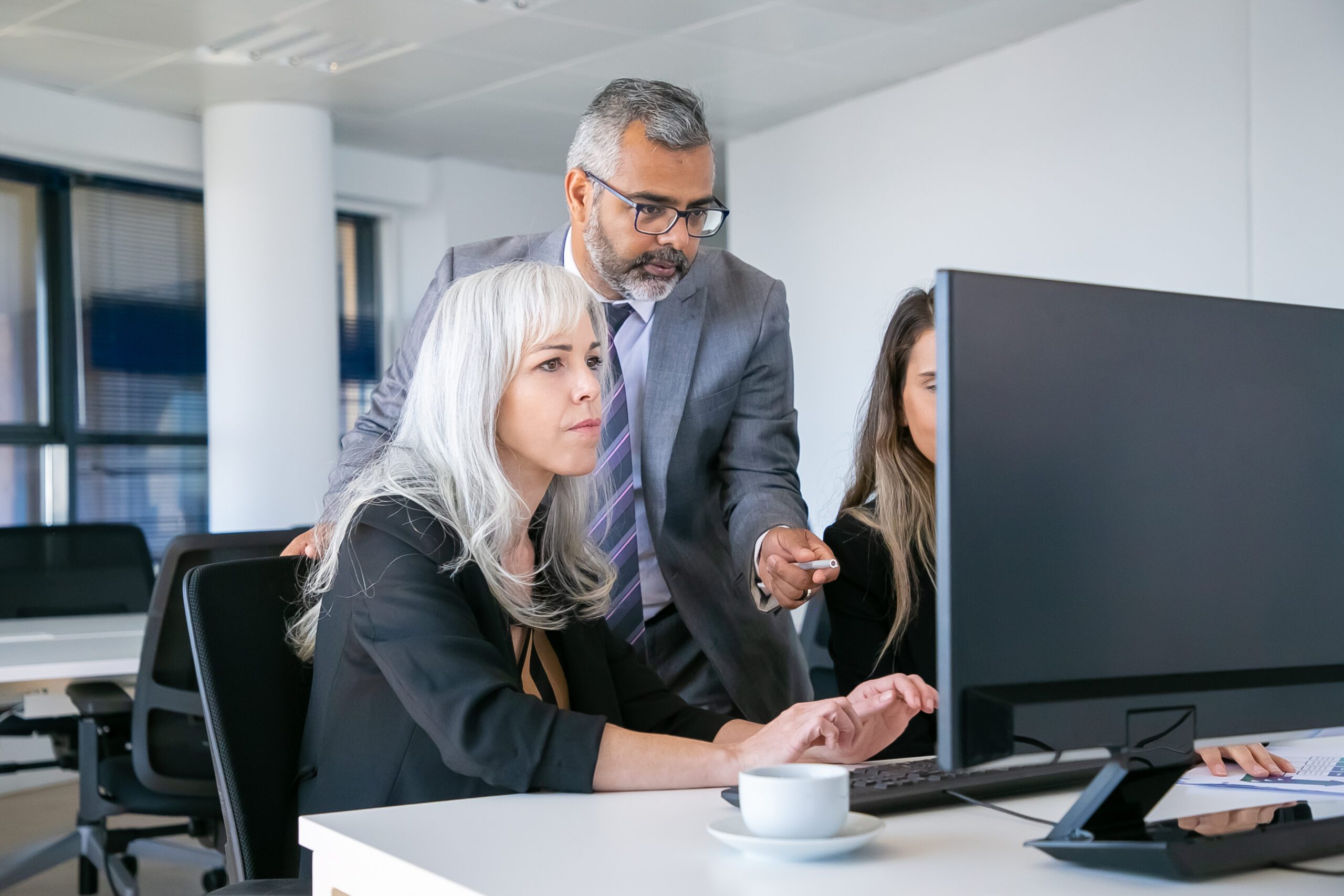 Boss looking and pointing at monitor